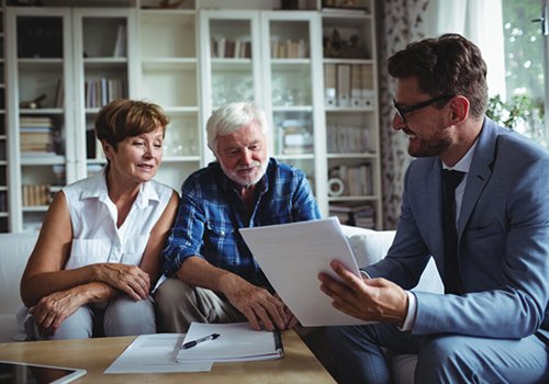 brokers talking with older couple